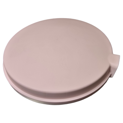 Pink round plastic planter lid on a white background